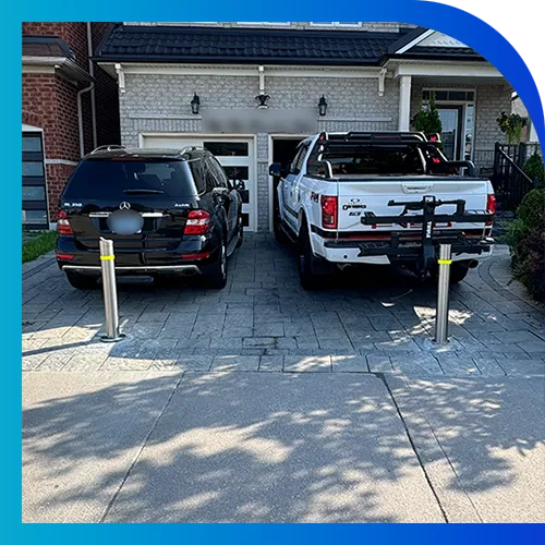 Car and Truck in Driveway with Bollards